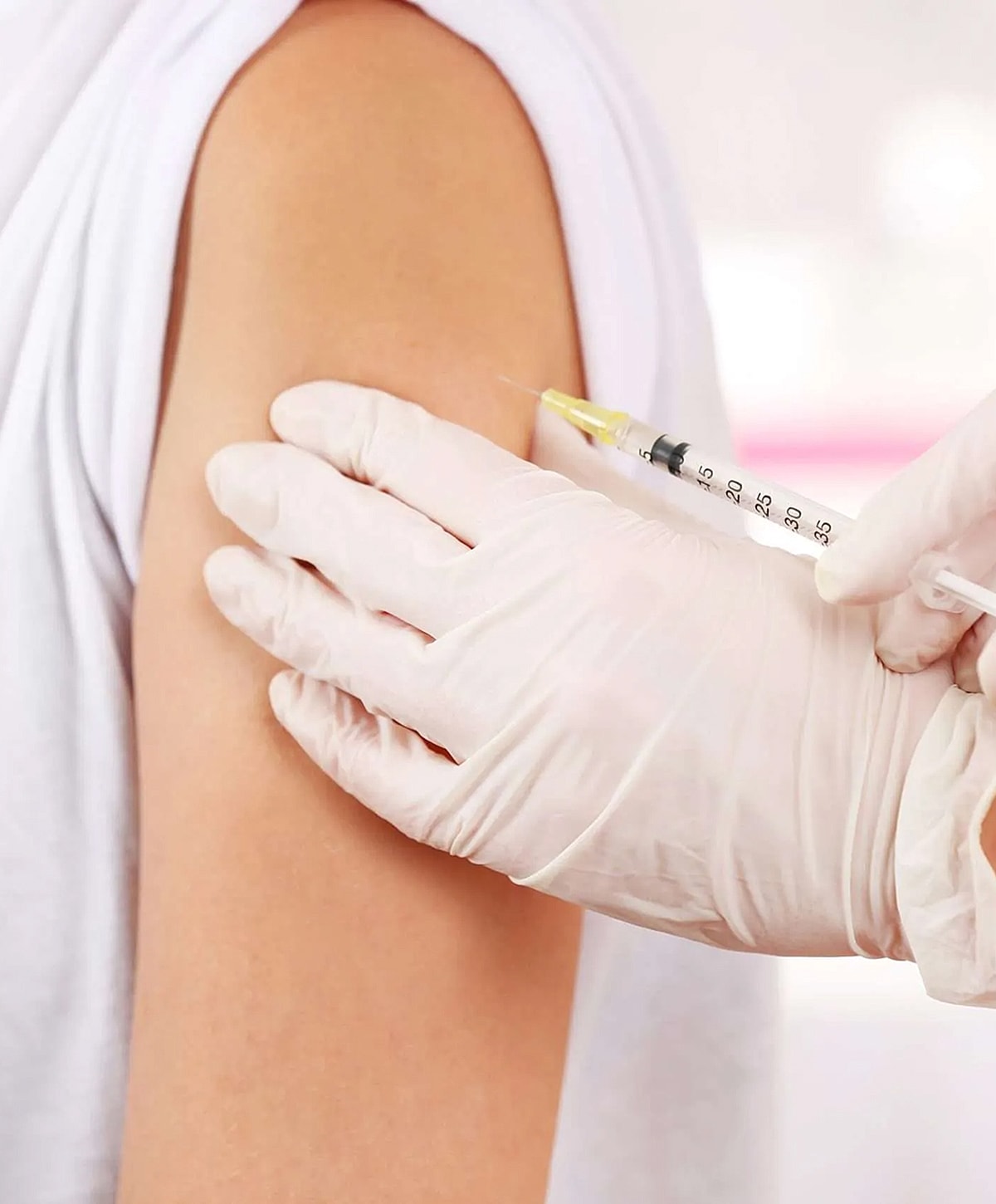 Person receiving vaccination in healthcare setting.